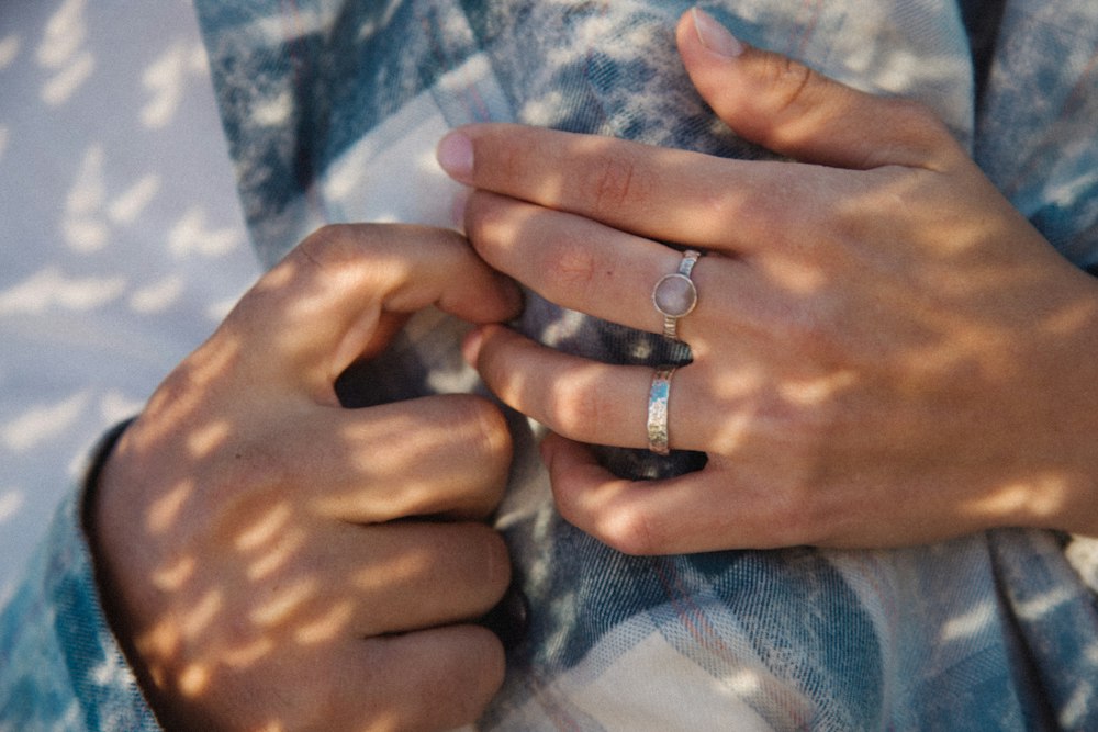 A couple's hands with wedding rings touching